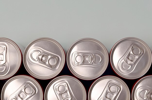 many new aluminium cans of soda soft drink or energy drink containers drinks manufacturing concept and mass production