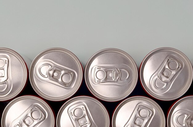 Many new aluminium cans of soda soft drink or energy drink containers Drinks manufacturing concept and mass production