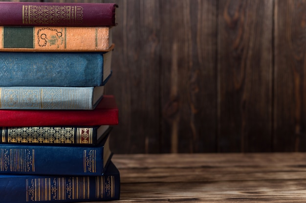 Many old books on wooden background