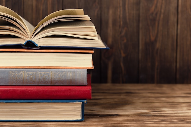 Many old books on wooden background