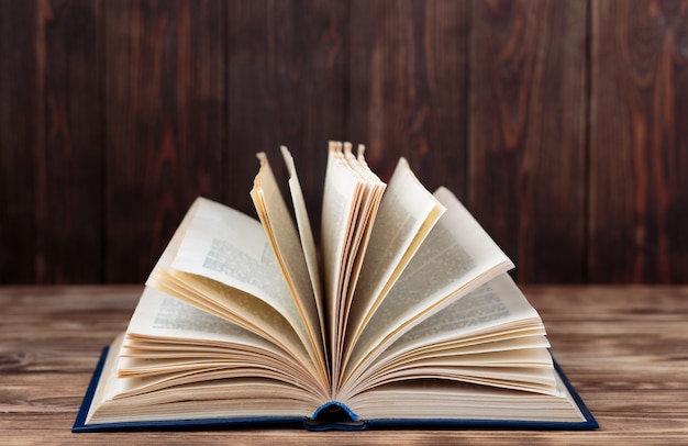 Many old books on wooden background