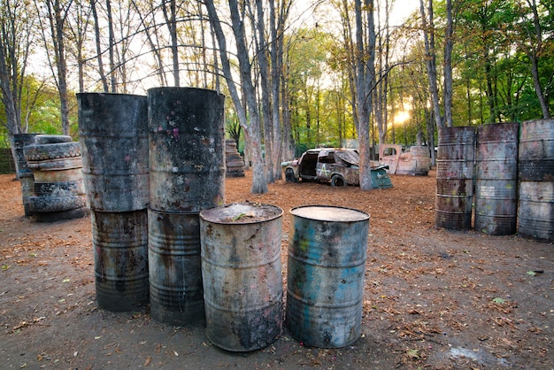 Many old round barrels at the base for playing paintball