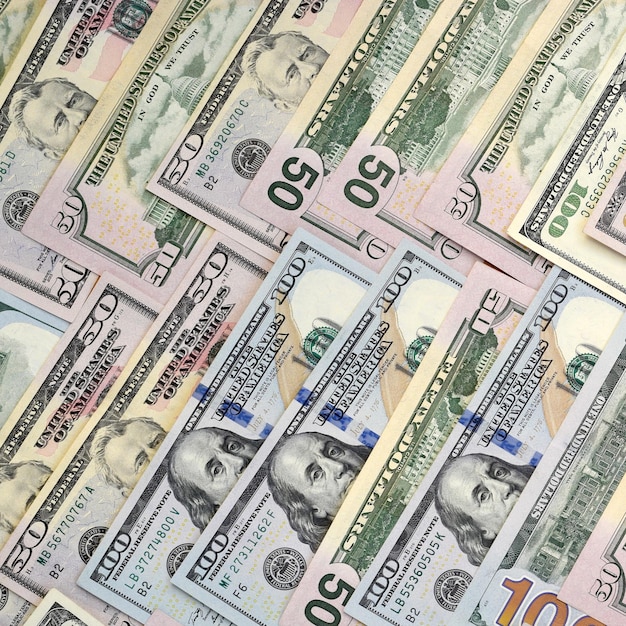 Many one hundred and fifty dollar bills on flat background surface close up Flat lay top view