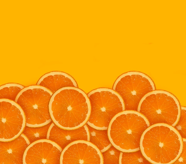 many oranges or orange slices on an orange background