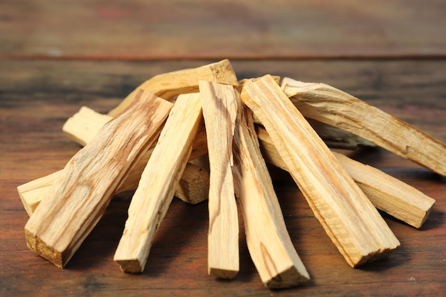 Many palo santo sticks on wooden table closeup