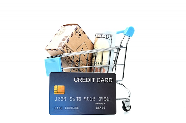 Many paper box money and credit card in shopping cart