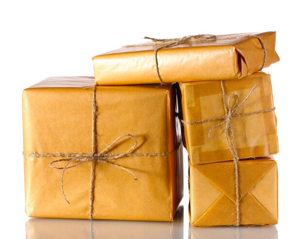 Many parcels wrapped in brown paper tied with twine isolated on white