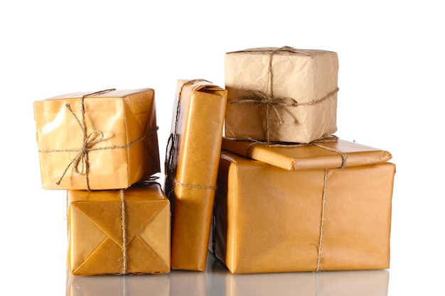 Many parcels wrapped in brown paper tied with twine isolated on white