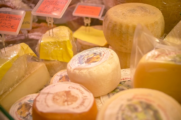 Many pieces of cheese ready to be sold at the supermarket