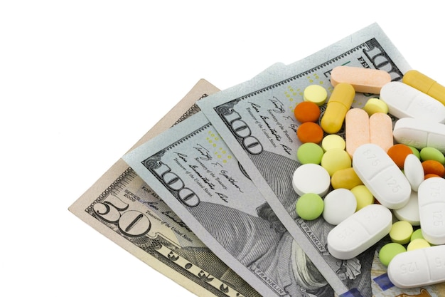 many pills and medical capsules on dollar bills