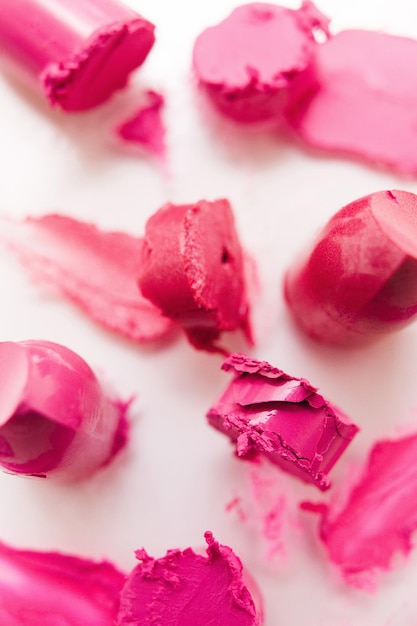 Many pink lipsticks samples on white background