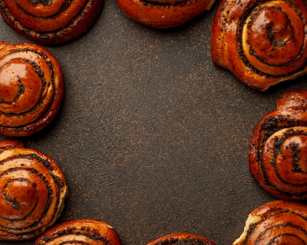 many poppy seed buns on a stone background  