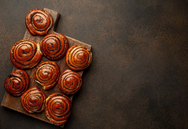 many poppy seed buns on a stone background  