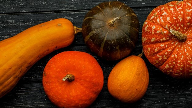 Many pumpkins on a wooden background. the concept of the fall harvest, halloween or thanksgiving