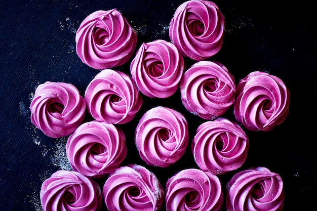 Many purple marshmallow on a dark surface A contrasting picture A work of culinary art