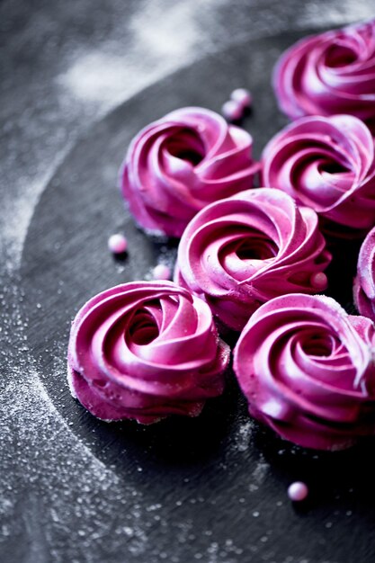 Many purple marshmallow on a dark surface A contrasting picture A work of culinary art