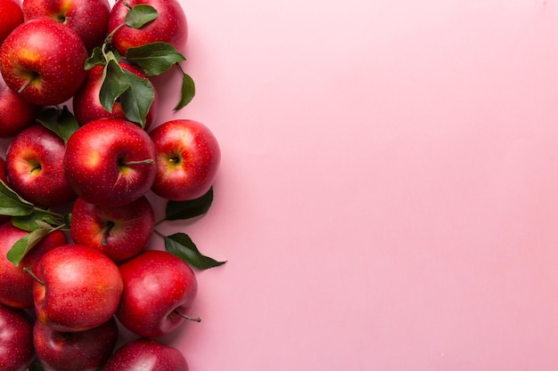 Many red apples on colored background, top view. Autumn pattern with fresh apple above view with copy space for design or text.