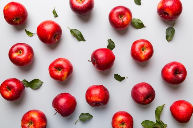 Many red apples on colored background top view Autumn pattern with fresh apple above view