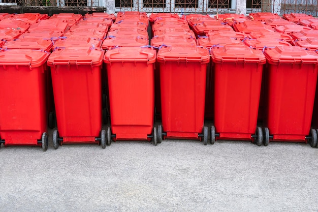 Many red hazardous waste bins in backside of field hospital waiting to be disposed of hygienically