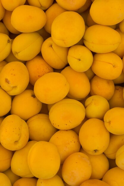 Many ripe orange apricots top view pattern