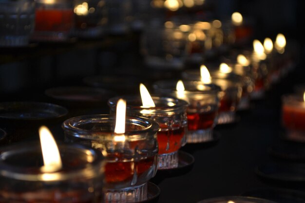 Many round glass candles with red wax