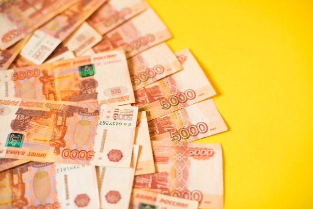 Many Russian rubles on a yellow background