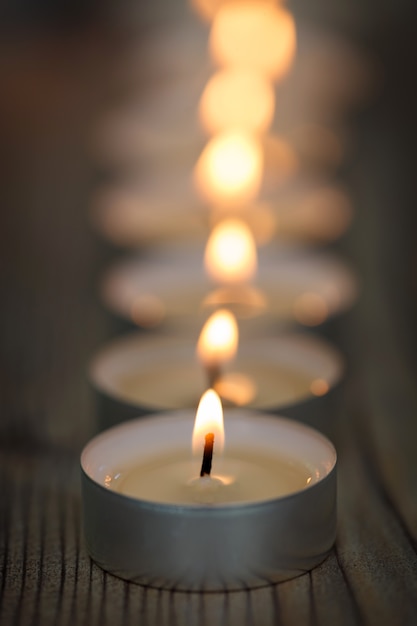 many small burning candles in line