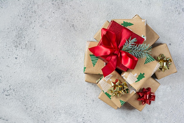 Photo many small gift boxes with a large red box in the center wrapped in holiday paper