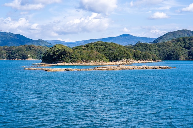 Many small islands over the blue ocean in sunny day, famous Kujukushima(99 islands) pearl sea resort islet in Sasebo Saikai National Park, Nagasaki, Kyushu, Japan.