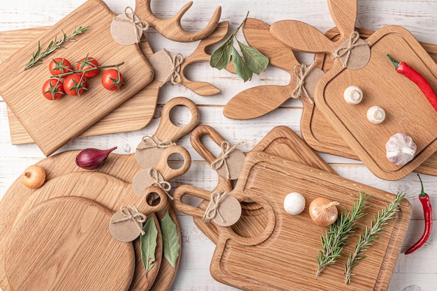 Many square wooden cutting boards with a handle cherry tomatoes and spices on a white background mockup with copy space for text top view