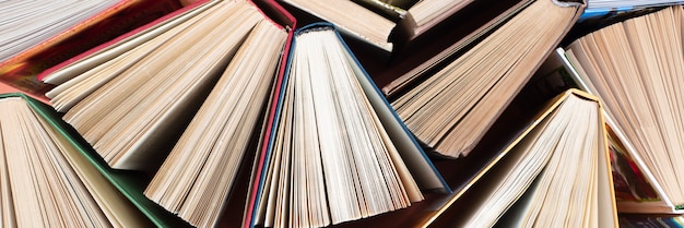 Many stacks of books. Old hardback books as background. Back to school.