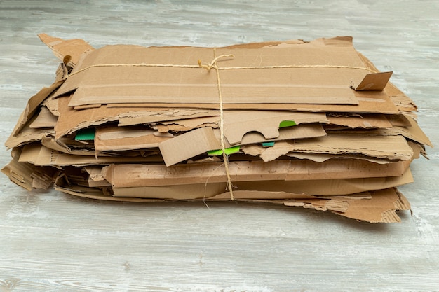 Photo many torn cardboard boxes assembled in a bundle, stack for recycling