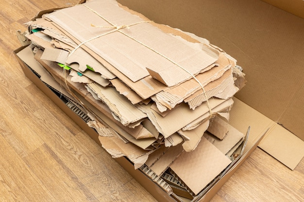 Photo many torn cardboard boxes assembled in a bundle, stack for recycling