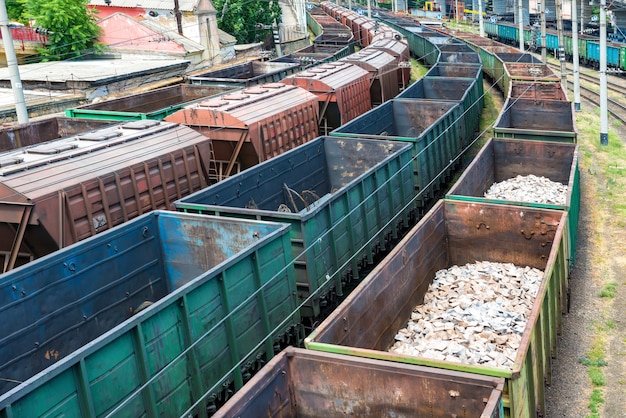 Many trains with cargo wagons on the railroad