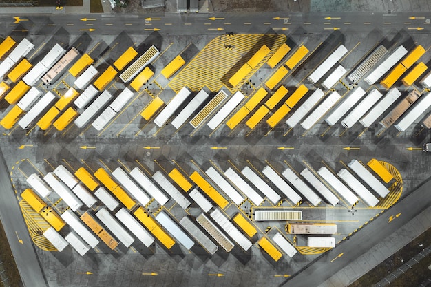 Many trucks and trailers are parked waiting to be loaded and unloaded transportation of goods aerial view of the car park