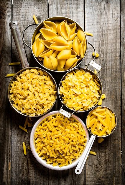 Many types of dry pasta in the pot.