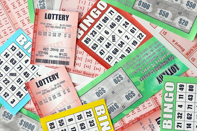 Many used lottery tickets bills with numbers and bingo playing boards in big pile Gambling and lottery paper stuff