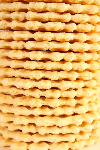 Many waffle cookies lie in a row one on one