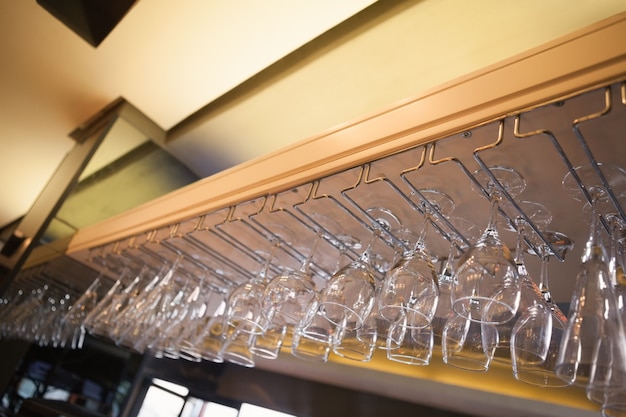 Many wine glasses hanging above the bar