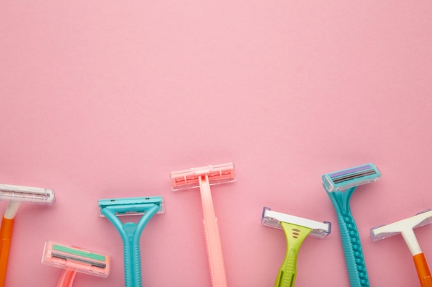 Many women razors on the pink background