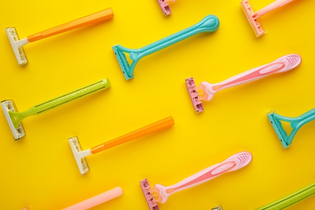 Many women razors on the yellow background