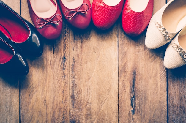 Many women's shoes are laid on wooden floors.