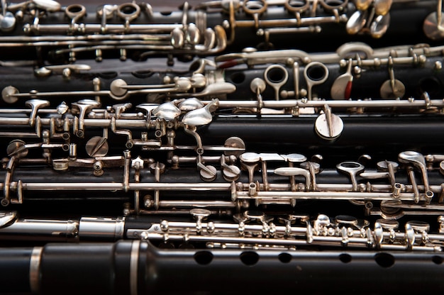 Many woodwind instruments lie on a wooden surface