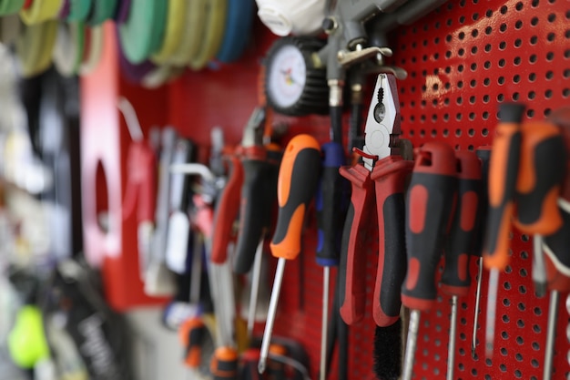 Many working tools hanging on wall in workshop closeup repair of household appliances concept