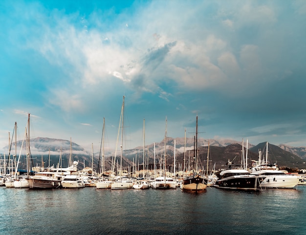 Many yachts in the background of the mountains