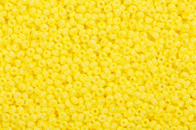 Many yellow glass beads on macro texture