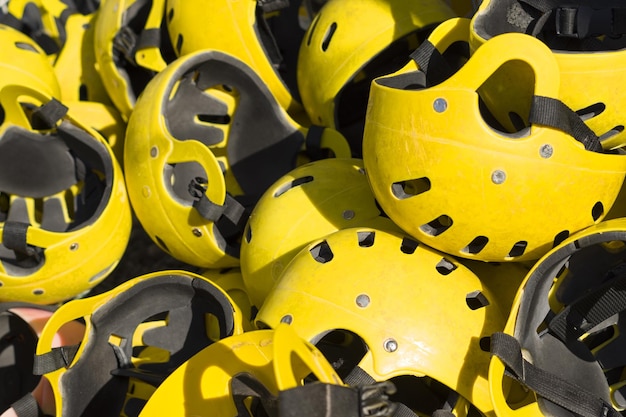 Many yellow life helmets safety and health care concept