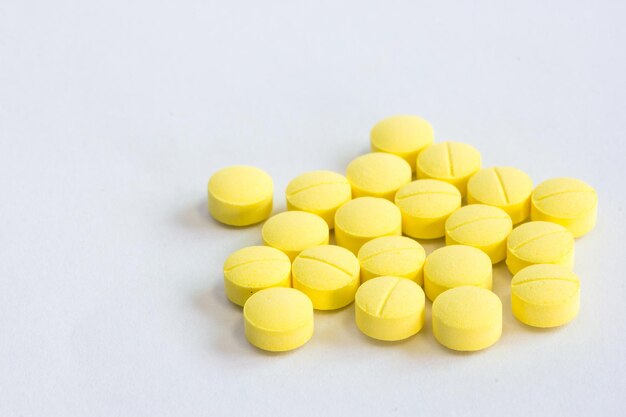 Many yellow medicine on the white background