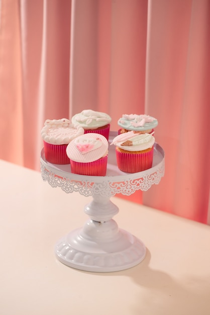 Many yummy cupcakes. Valentine sweet love cupcake on table on light background