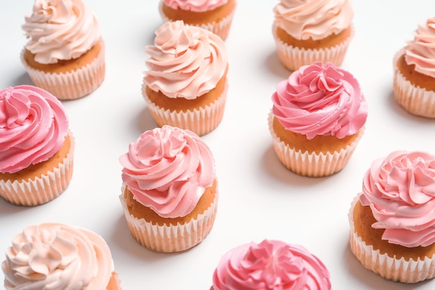 Many yummy cupcakes on white background